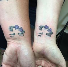 two people with matching tattoos on their arms