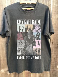 an unfollow t - shirt hanging on a wooden fence with the words erygah badu