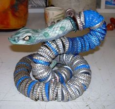 a blue and silver snake sculpture sitting on top of a counter