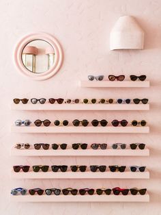 there are many pairs of sunglasses on the wall