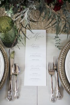 a table setting with silverware and place settings