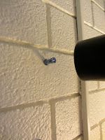 a close up of a toilet paper dispenser on the wall next to a door