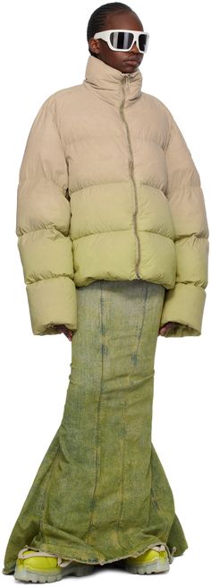 Garment-dyed DIST-certified down-filled quilted nylon taffeta jacket. Gradient pattern throughout. · Funnel neck · Zip closure · Welt pockets · Embroidered logo patch at sleeve · Inset rib knit cuffs · Zip fastening at back collar · Webbing strap at back · Patch pockets at interior · Fully lined · Logo-engraved silver-tone hardware Part of the Rick Owens x Moncler collaboration. Supplier color: Acid degrade Fill: 90% goose down, 10% goose feather. Green Nylon Puffer Jacket With Padded Collar, Spring Duck Down Puffer Jacket With Padded Collar, Green Fitted Puffer Outerwear, Spring Nylon Puffer Jacket With Padded Collar, Spring Green Quilted Puffer Jacket, Fitted Down Puffer Jacket For Spring, Taffeta Jacket, Gradient Pattern, Rick Owens Jacket