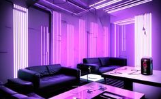 a living room filled with furniture and purple lighting on the walls, along with two black couches