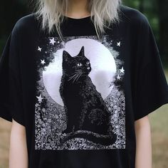 Black Cat In Front Of Moon T-Shirt, Green Witch Shirt, Witchy Clothing, Cottagecore, Goth Aesthetic, Wiccan Witchcraft, Dark Academia Embrace The Mystical And Enchanting Vibes With Our Black Cat In Front Of Moon T-Shirt. This Shirt Is Perfect For Those Who Love The Witchy, Cottagecore, Goth Aesthetic, And Wiccan Witchcraft, Blending Dark Academia Style With A Touch Of Magic. Material: Made From High-Quality, Soft Cotton Blend Fabric, Ensuring Comfort And Durability For All-Day Wear. Design: Feat Black Relaxed Fit T-shirt With Cat Print, Black Relaxed Fit Tops With Cat Design, Black Relaxed Fit Top With Cat Design, Cottagecore Goth Aesthetic, Clothing Cottagecore, Witchy Cottagecore, Wiccan Rituals, Witchy Clothing, Dark Academia Style