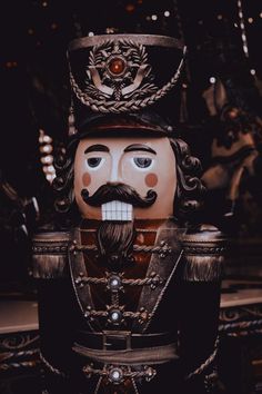 a wooden statue with a mustache and hat on it's head