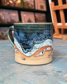 a coffee cup sitting on top of a wooden table