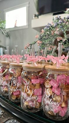 several jars filled with candy sitting on top of a table