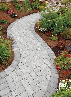 a stone path in the middle of a garden