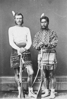 two men in native garb standing next to each other