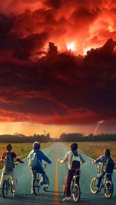 three children riding bikes on an empty road under a red sky with lightning in the distance