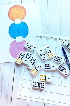 domino board pieces and scissors on a table