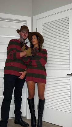 a man and woman dressed up in costumes standing next to each other with their arms around each other