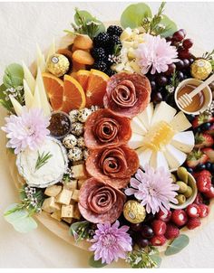 a platter filled with assorted fruits and cheeses