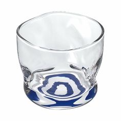 a shot glass with the letter o on it's side and an oval design