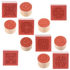 six red rubber stamps with designs on them