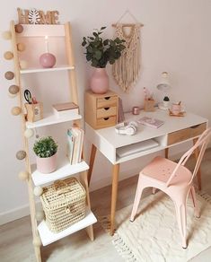 a white desk topped with a pink chair next to a wooden shelf filled with books