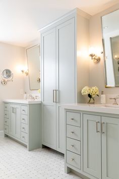 a large bathroom with two sinks and mirrors