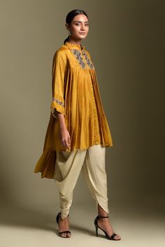 Mustard three quarter sleeve high low kurta, elevated with pearl embellished yoke. Paired with ivory dhoti pant.
Component: 2
Pattern: Embellished
Type Of Work: Sequins
Neckline: Stand Collared Neck
Sleeve Type: Three Quarter Sleeves
Fabric: Kurta: Organza, Dhoti: Satin 
Color: Yellow
Other Details: 
Sequin embellished cuffs
Concealed placket
Occasion: Mehendi and Haldi - Aza Fashions Ruffled Saree, Sequins Lehenga, Organza Kurta, Asymmetric Kurta, Dhoti Saree, Grey Saree, Dhoti Pants, Sharara Set, Two Sisters