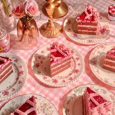 several pieces of cake on plates with pink flowers