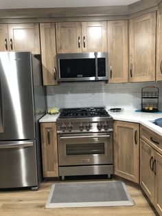 a kitchen with stainless steel appliances and wooden cabinets