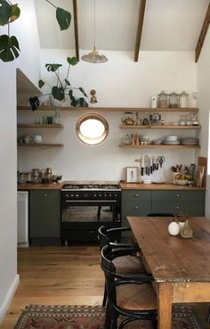 the kitchen is clean and ready to be used for cooking or dining, with shelves above the stove