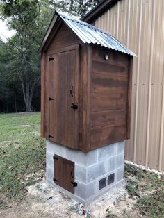 a small outhouse with a metal roof