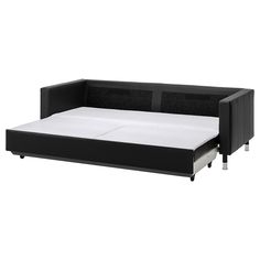 a black sofa bed with white sheets and pillows on the bottom half is open to reveal a pull out mattress