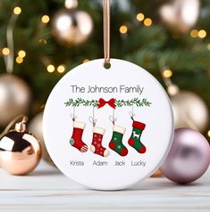 personalized christmas ornament with stockings hanging from it