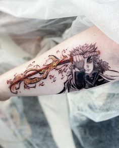 a woman's arm with an artistic tattoo design on the left side of her arm