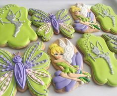 decorated cookies in the shape of tinkerbells and fairy princesses are on display