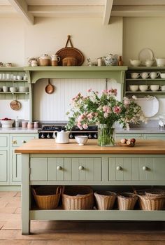 a kitchen with lots of green cabinets and baskets on the counter top in front of it