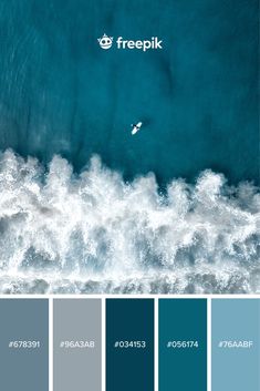 an aerial view of the ocean with blue hues and white waves in the foreground