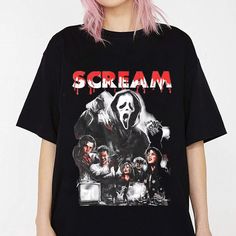 a woman with pink hair wearing a black scream t - shirt