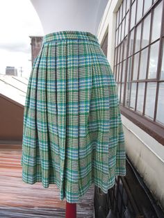 "Vintage 50's-60's perfect wool plaid pleated skirt. Main colors, are cream, teal and green. Great condition; no notable flaws. Hidden zip with button closure. Unlined. Waist:12.25\" across (24.5\" waist, a 25\" waist would be snug but it has a tiny bit of give) Length:21.25\" Hips:open (pleated)" Green Accordion Pleats Skirt, Fitted Green Accordion Pleated Skirt, Retro Knee-length Pleated Skirt, Vintage Plaid Full Skirt, Vintage Pleated Plaid Skirt, Retro Plaid Full Skirt, Retro Full Plaid Skirt, Retro Full Skirt In Plaid, Retro Green Pleated Skirt