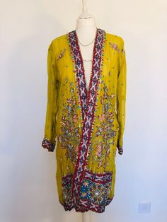 "A Stunning Boho Jacket , handmade from a Vintage Indian Sari. so a complete one of a kind. A Wonderfully Chic and Flattering Golden Ochre Silk Chiffon Jacket, Beautifully embellished allover with an exquisite design in layers of contrasting Red,Turquiose and Silver. The jacket is decorated with 1000's of Sparkling Silver and Gold Sequins,Shimmering bugle beads,Hand embroidery and Diamante Crystals that all Glitter and catch the Light . This Lovely piece is truly unique ,and will look stunning d Traditional Fitted Embellished Outerwear, Fitted Traditional Embellished Outerwear, Fitted Hand Embellished Festive Outerwear, Traditional Embellished Festive Outerwear, Traditional Embroidered Outerwear For Parties, Festive Embellished Outerwear For Festivals, Festive Hand Embellished Long Sleeve Outerwear, Bohemian Outerwear For Festive Wedding, Fitted Bohemian Outerwear For Festive Occasions