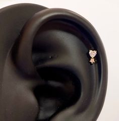 a close up of an ear with a diamond in it