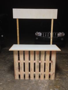 a bench made out of wooden pallets in a garage