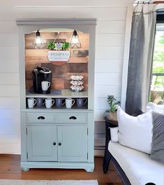 a blue cabinet with coffee cups on it