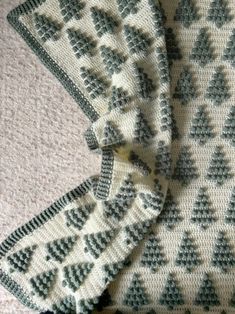 three pieces of knitted fabric with trees on them