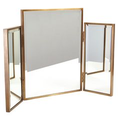 a large mirror sitting on top of a white floor