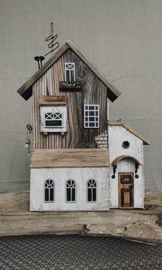 a doll house made out of wood and white paint