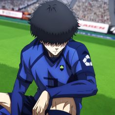 an anime character sitting on the ground in front of a soccer field with his head down