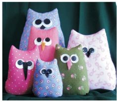 four stuffed owls sitting next to each other