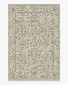 a beige rug with blue and green designs on the bottom, in an ornate pattern