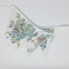 three floral buntings hanging on a white wall