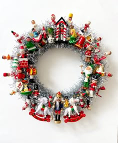 a christmas wreath made out of ornaments and tinsel