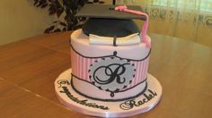 a graduation cake with a hat on top