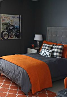 a bedroom with orange and gray decor on the walls