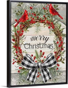 a christmas wreath with two red birds on it and the words merry christmas written in black